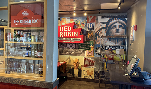Red Robin signs, local references, and pop-culture artwork in a restaurant alcove