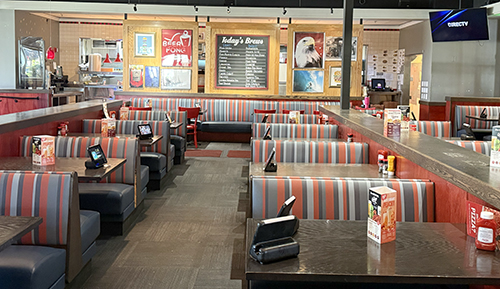 Striped booths and historical wall displays in a Red Robin dining room