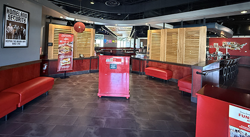 Red benches, host stand, and wooden screens in the Red Robin lobby