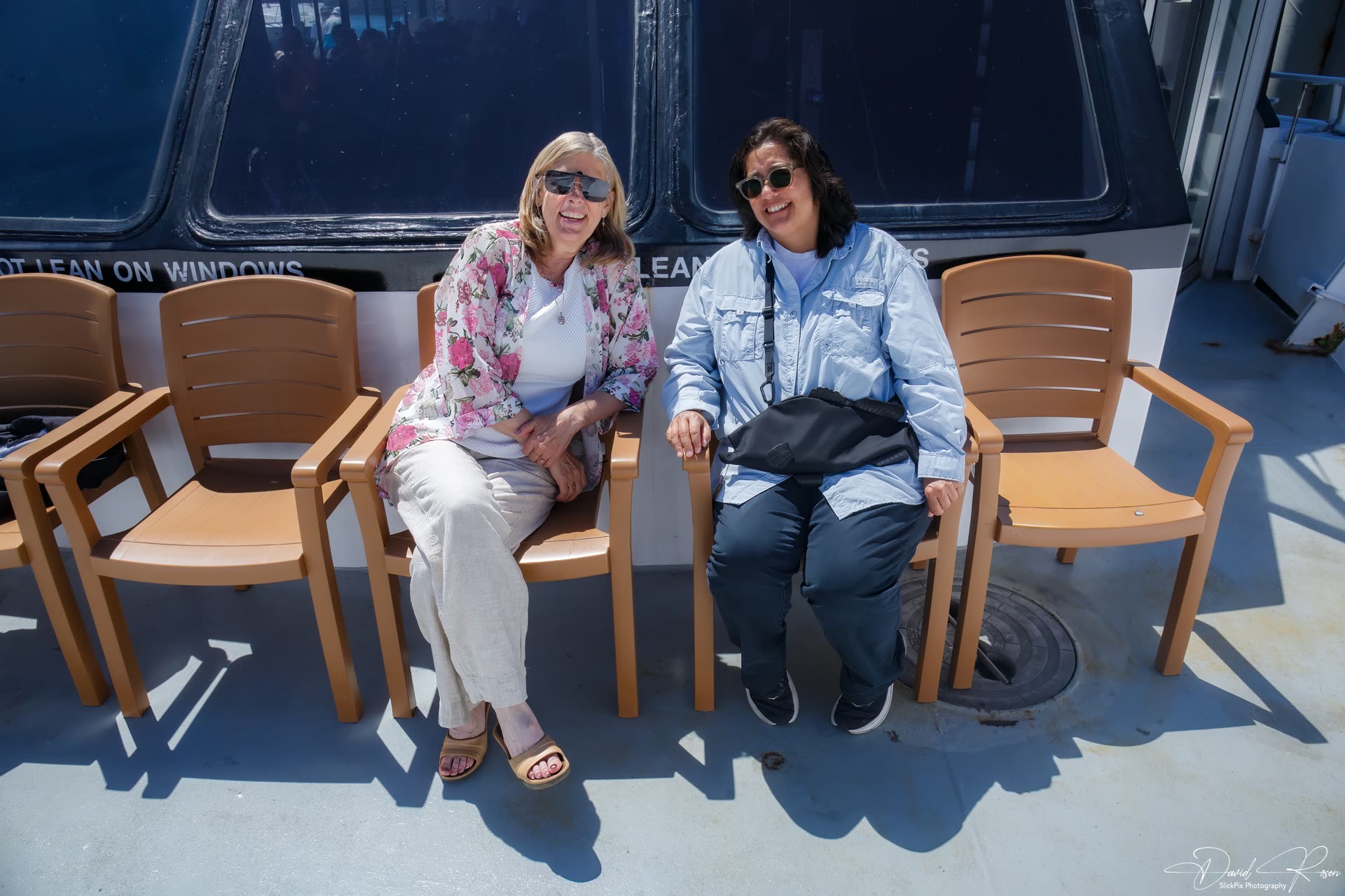 Two guests relax in deck chairs aboard the Lady Mary.