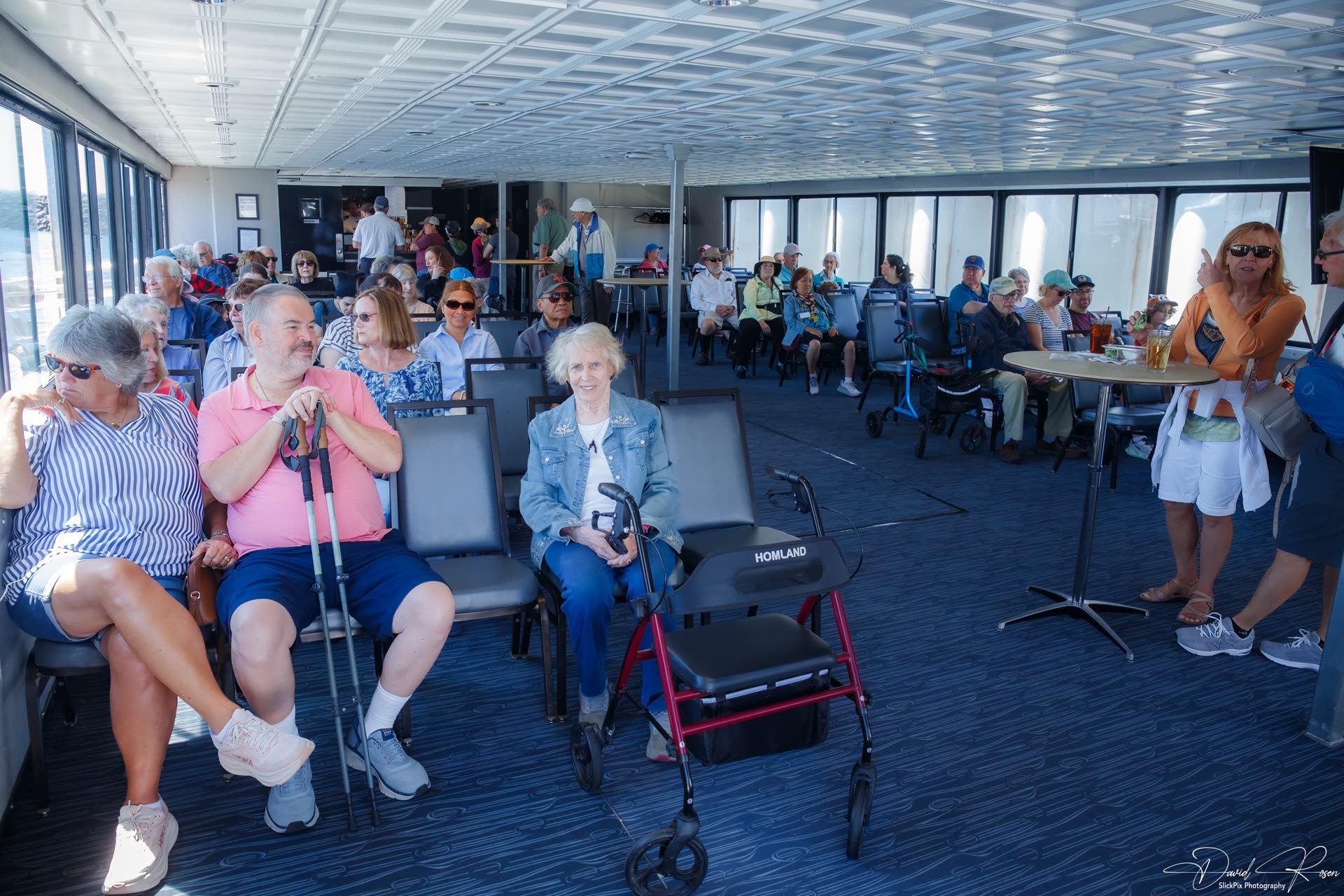 Passengers sit together in the enclosed passenger cabin.