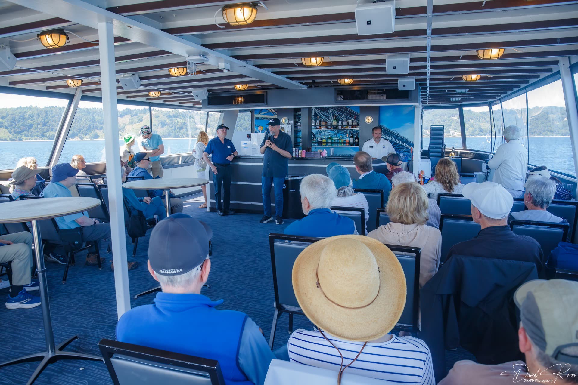 Passengers sit and stand inside the cabin during the cruise.