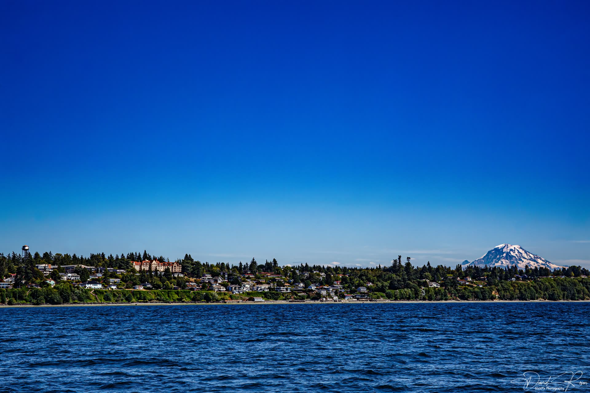 Lady Mary seen across the water with Mount Rainier rising in the distance.